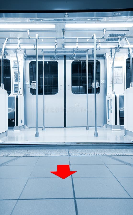 Here are doors opened in metro station with red arrow on the ground. Here are doors opened in metro station with red arrow on the ground.