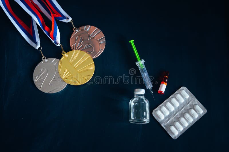 Doping in sport, concept photo. Medal set, drugs, Medicine bottle for injection medical glass vials. High Quality Photo. Natural Light