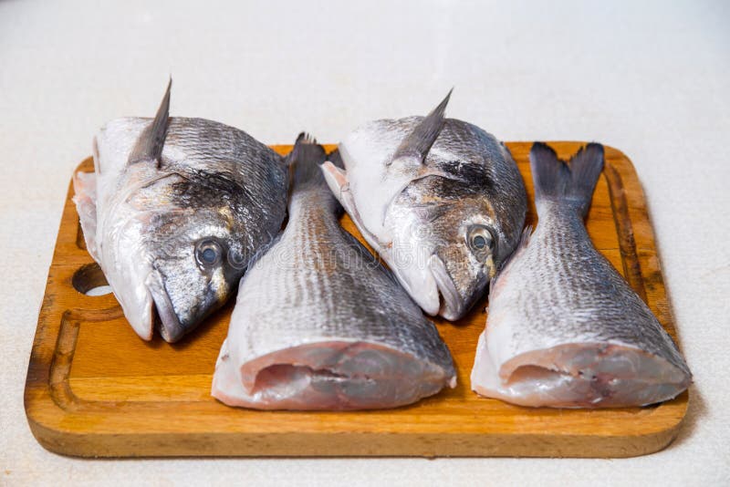 Dorado Fish on a Cutting Board Knife Cut Half Stock Photo Image of