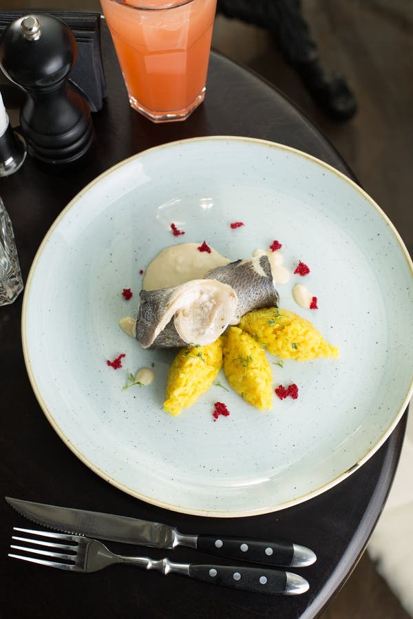 Dorado White Fish with Yellow Rise on the Table at Restaurant Stock