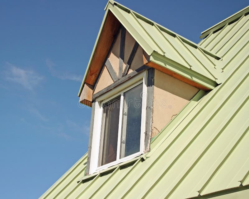 Dormer, also known as a rooftop window with sage green aluminum siding