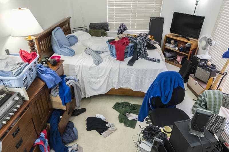 Very messy, cluttered teenage boy`s bedroom with piles of clothes, music and sports equipment. Very messy, cluttered teenage boy`s bedroom with piles of clothes, music and sports equipment.