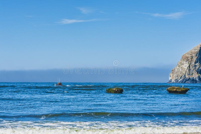 Dory Board Passes By Haystack Rock Editorial Photo - Image 