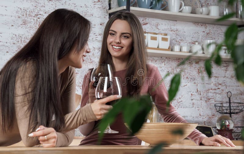 Dos Chicas Guapas Tomando Un Vaso De Vino Tinto En La Cocina Foto De
