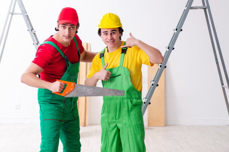 Dos contratistas de los trabajadores que trabajan dentro fotografía de archivo Dos contratistas de los trabajadores que trabajan dentro fotografía de archivo