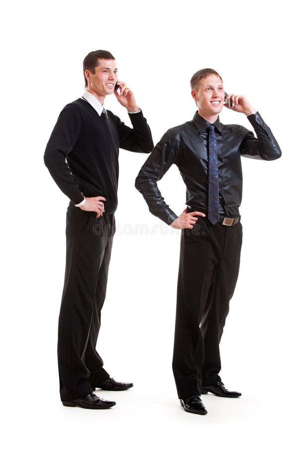 Dos hombres de negocios que hablan en el teléfono imágenes de archivo libres de regalías Dos hombres de negocios que hablan en el teléfono imágenes de archivo libres de regalías
