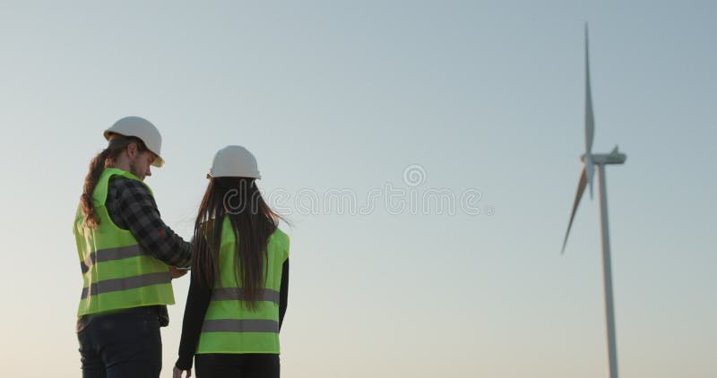 Dos ingenieros dándose la mano Vista lateral de una joven sonriendo cuando se estrechan las manos con un trabajador de la constru