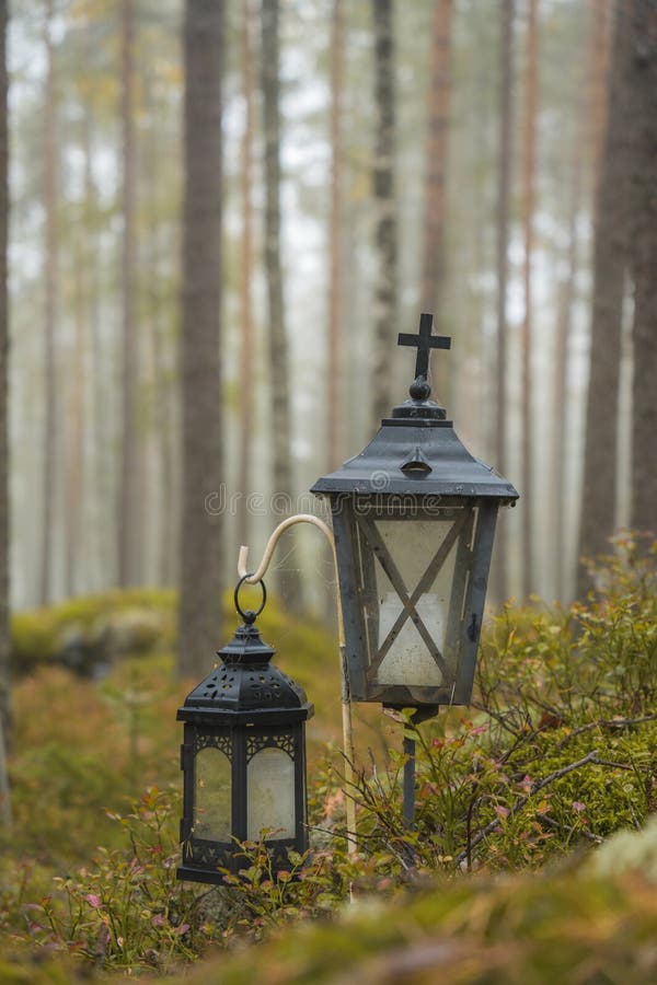 Two grave lanterns in a misty forest, close up. Two grave lanterns in a misty forest, close up