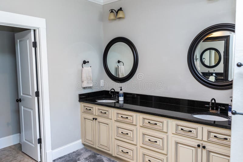white bathroom cabinets with dark countertops