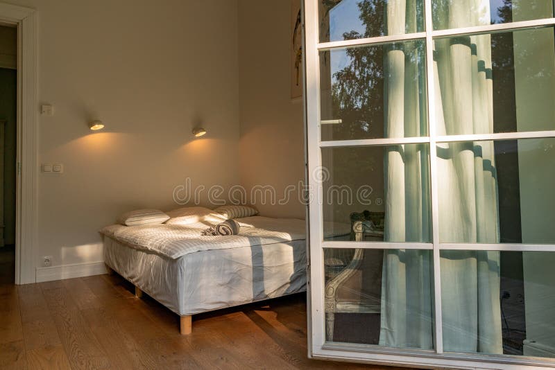 Double Bed With Doors Wide Open. Stock Photo Image of blanket
