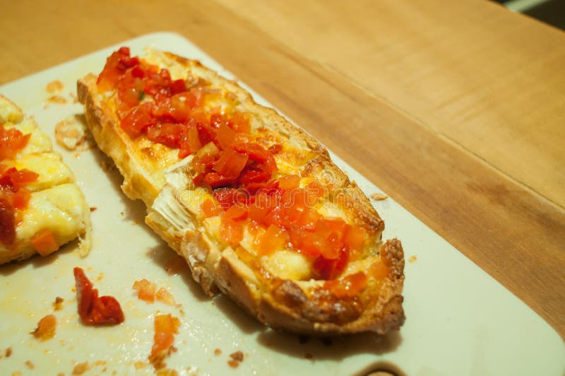 Double brusqueta with italian tomatoes and cheese, on the table, 45 degree angle stock photo Double brusqueta with italian tomatoes and cheese, on the table, 45 degree angle stock photo