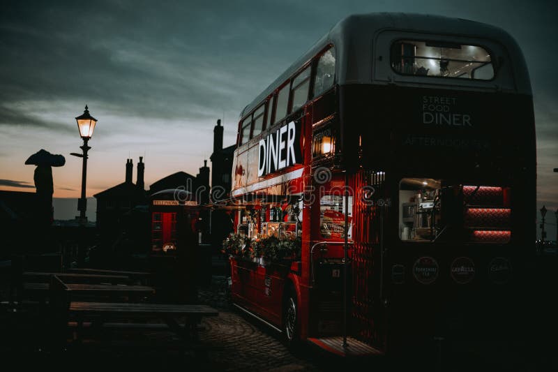Double-decker Diner bus parked in the sunset royalty free stock photo