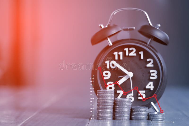 Double exposure of alarm clock and step of coins stacks on working table with financial graph chart, time for savings money stock photography