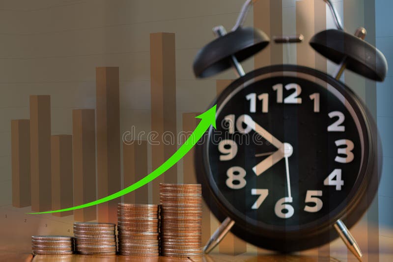 Double exposure of alarm clock and step of coins stacks on working table with financial graph, time for savings money concept. stock image