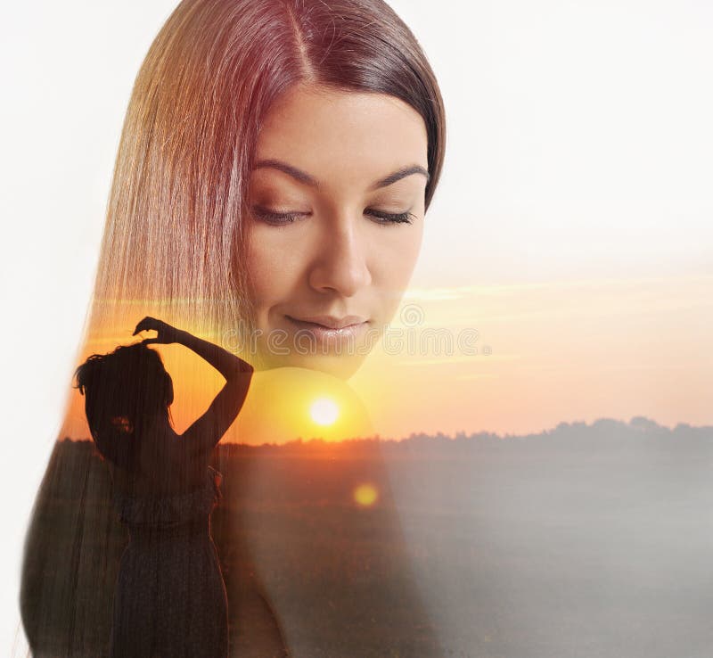 Double exposure of beautiful woman and sundown evening glow stock image