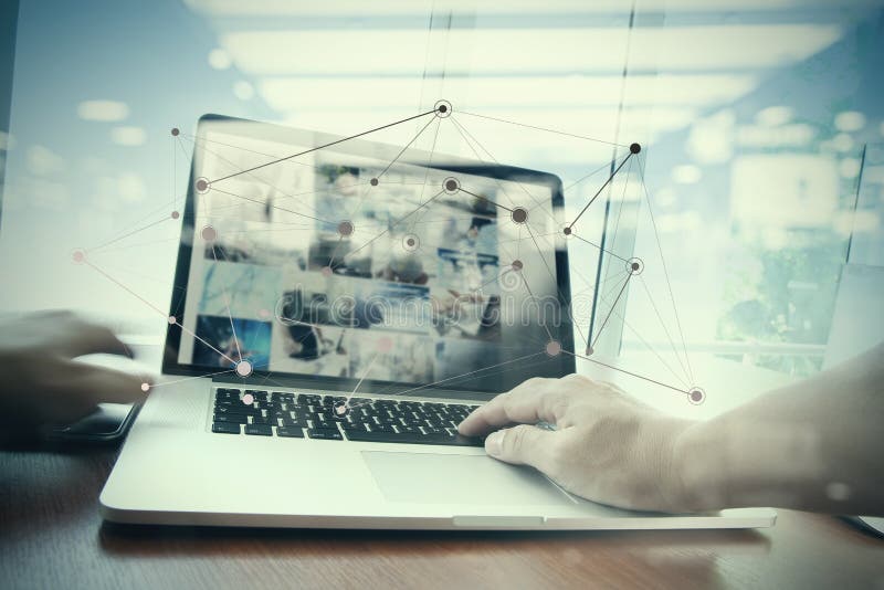 Double exposure of business man hand working on laptop computer on wooden desk with social media network diagram