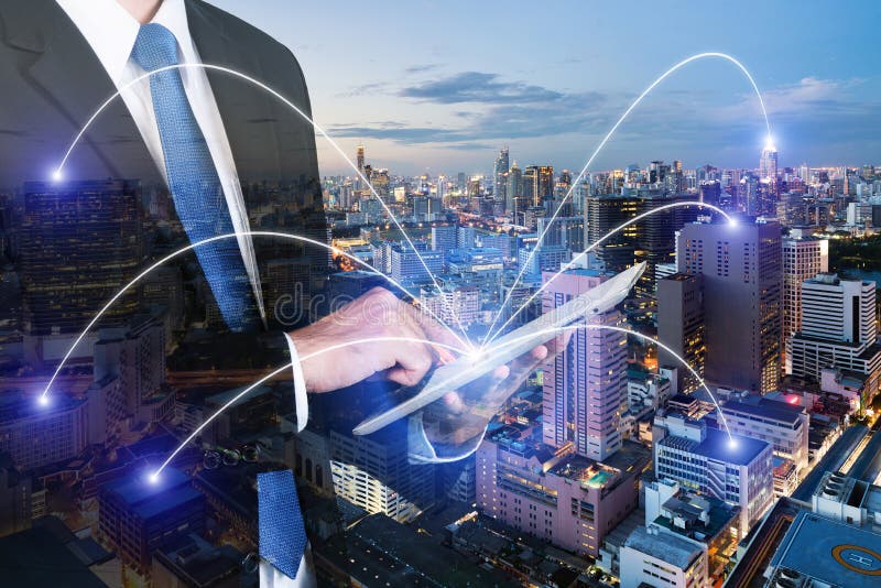Double exposure of businessman using digital tablet pc with network connection of Bangkok city. Network connection concept stock photography