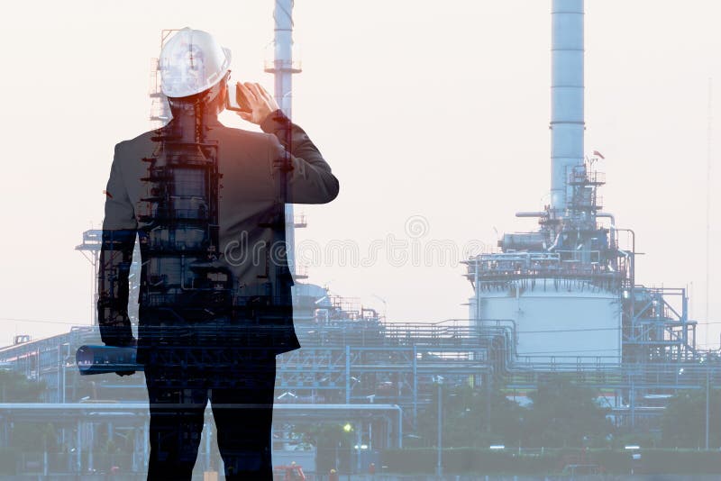 Double exposure of Engineer talking smartphone with oil refinery royalty free stock photography Double exposure of Engineer talking smartphone with oil refinery royalty free stock photography