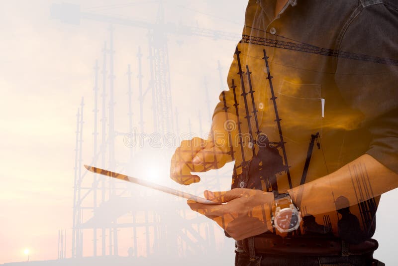 Double exposure the engineering using tablet checking job stock image