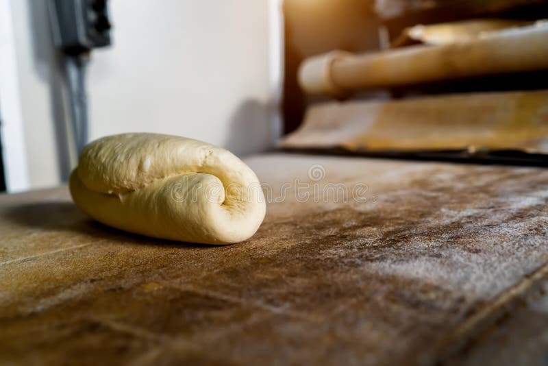 The dough for baking bread moves along the conveyor in close-up stock photo