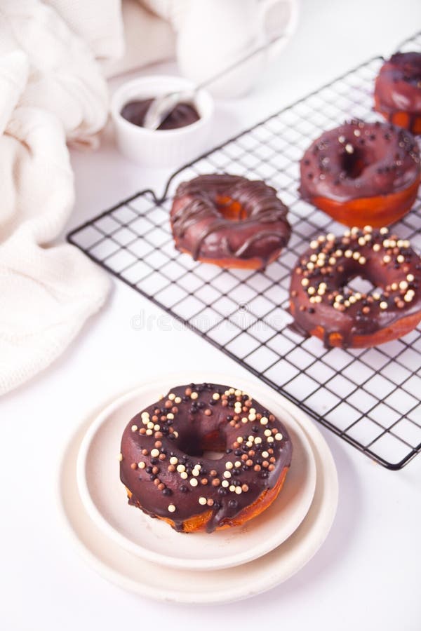 Doughnut on the Baking Rack and on the Plate Glazed with Chocolate