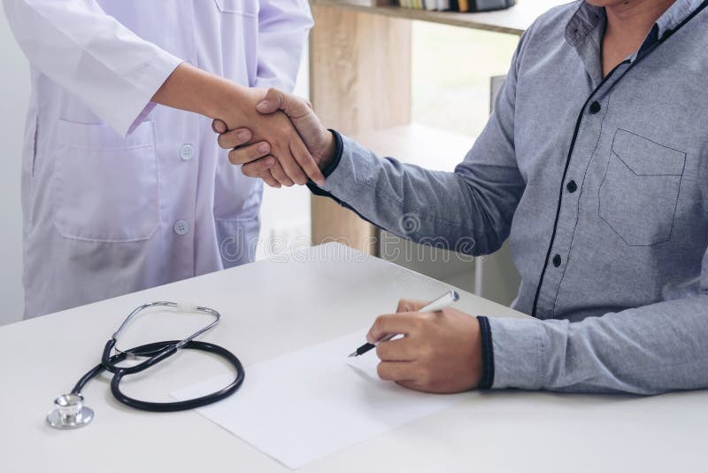 Doctor and patient shaking hands after treatment. Doctor and patient shaking hands after treatment.