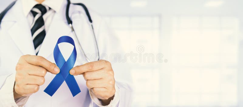 Doctor Holds Blue Ribbon, Colon cencer Awareness. Symbolic concept raising awareness concerns help campaign on people living Colorectal cancer illness. Doctor Holds Blue Ribbon, Colon cencer Awareness. Symbolic concept raising awareness concerns help campaign on people living Colorectal cancer illness.