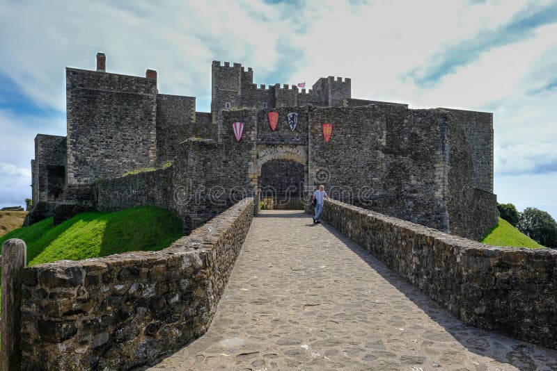 Dover Castle, Dover, Kent, UK - August 17, 2017: view of Castle keep and King Henry's tower. Summer shot with man standing at the entrance. Dover Castle, Dover, Kent, UK - August 17, 2017: view of Castle keep and King Henry's tower. Summer shot with man standing at the entrance.