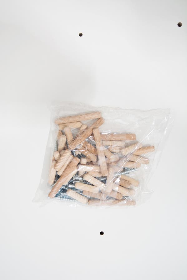 Dowels and Confirmates in Plastic Pack on White Furniture Shield Stock ...