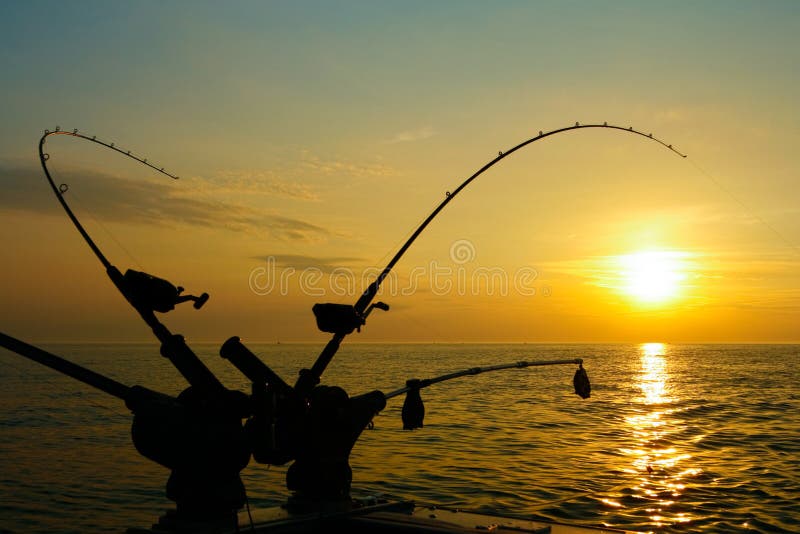 A view of downriggers and fishing rods which are used to catch salmon and lake trout on Lake Ontario and around the world. A view of downriggers and fishing rods which are used to catch salmon and lake trout on Lake Ontario and around the world.