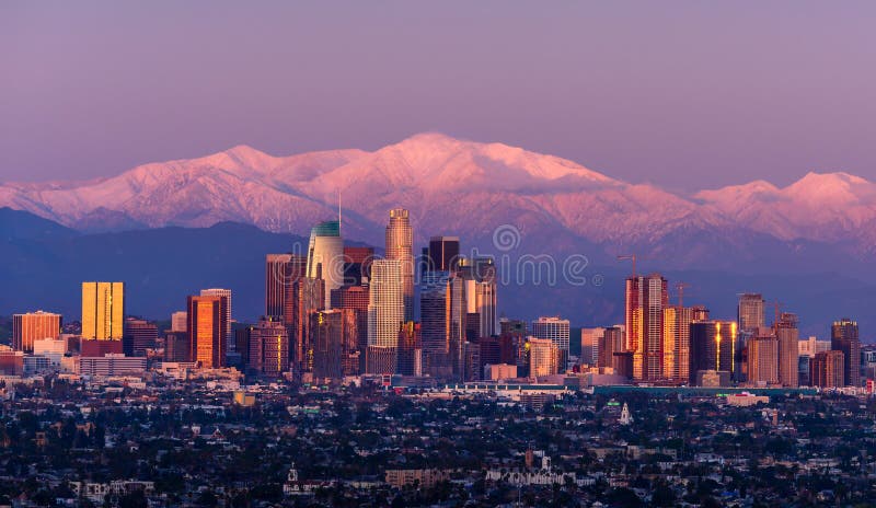 Downtown Los Angeles skyline with snow capped mountains