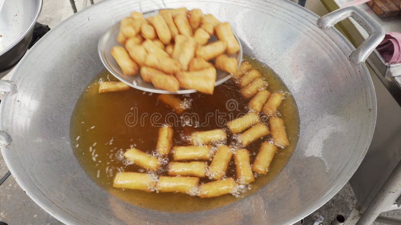 Dozens of crispy deep-fried spring roll in cooking oil