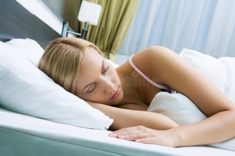 Photo of pretty woman sleeping peacefully in white bed. Photo of pretty woman sleeping peacefully in white bed