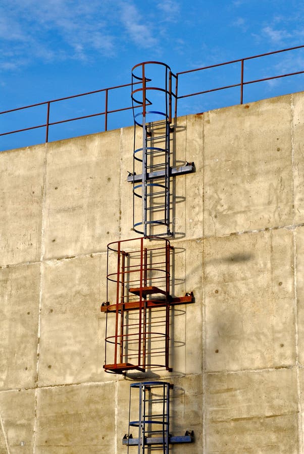 Metal ladder on a concrete wall. Metal ladder on a concrete wall