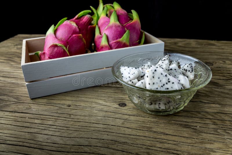 Dragon Fruit in the bowl on the wooden table, Selective focus. royalty free stock photos