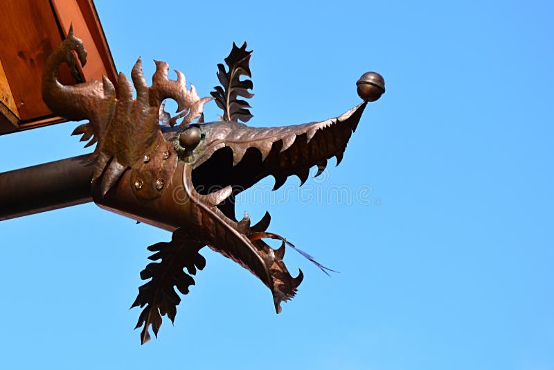 Dragon Head Made of Plate Metal As Gutter Spout Gargoyle on Residental