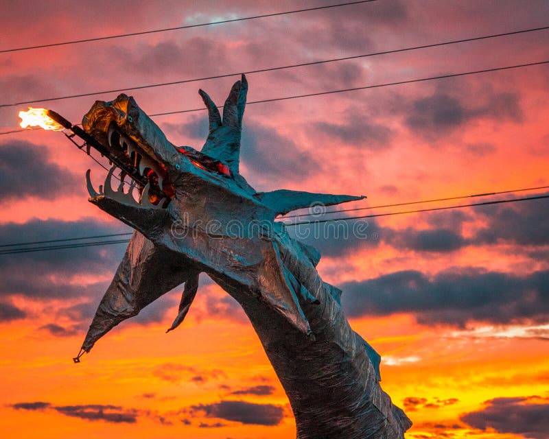 Dragon sculpture breathing fire at sunset at Artprize 9 in Grand Rapids Michigan stock photos Dragon sculpture breathing fire at sunset at Artprize 9 in Grand Rapids Michigan stock photos