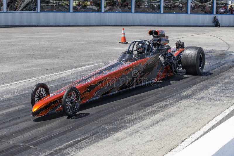 NHRA National Open July 12â€“13-14, 2015, picture of top fuel dragster on the track in approach to starting line. NHRA National Open July 12â€“13-14, 2015, picture of top fuel dragster on the track in approach to starting line