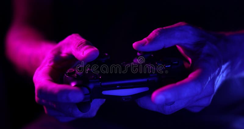 Drahtloser Videospielcontroller in der Hand von Spielern. Neonlicht