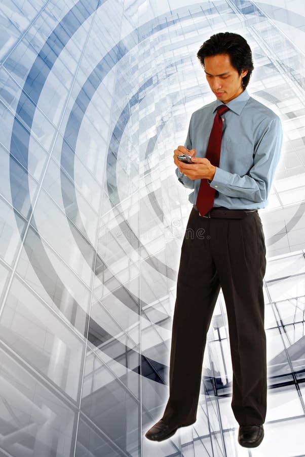 Young Asian Business Man / Entrepreneur using the wireless / Wi-Fi connection on his mobile phone/ smartphone. Modern Building background. Young Asian Business Man / Entrepreneur using the wireless / Wi-Fi connection on his mobile phone/ smartphone. Modern Building background.