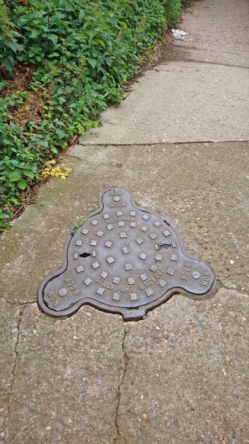Drain on the Road To Prevent Flooding on the Road. a Manhole Cover in