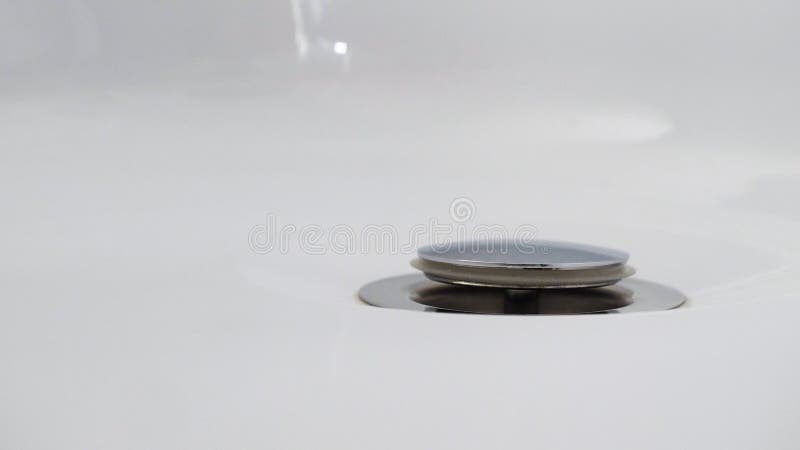 Drain hole in metal sink, close up view. Mechanically adjustable drain plug closeup. Mechanically adjustable drain plug stock image Drain hole in metal sink, close up view. Mechanically adjustable drain plug closeup. Mechanically adjustable drain plug stock image