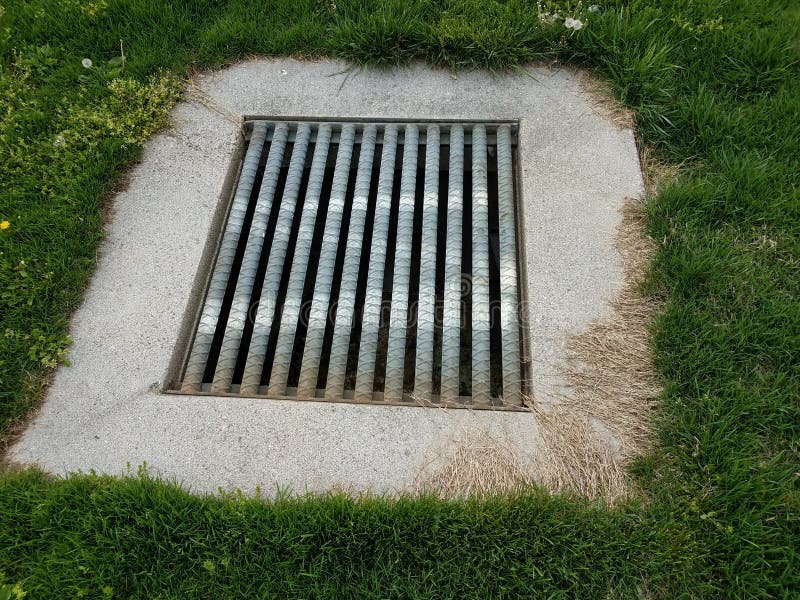 Drain with Metal Grate Bars and Green Grass Stock Photo Image of