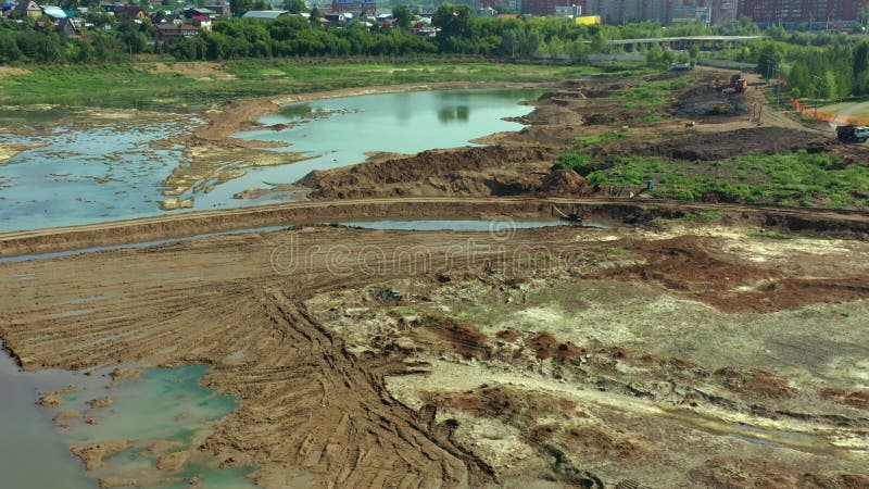 Drained lake as viewed by dron. Aerial view of drainage of the construction site. Cleaning the bottom of the lake from