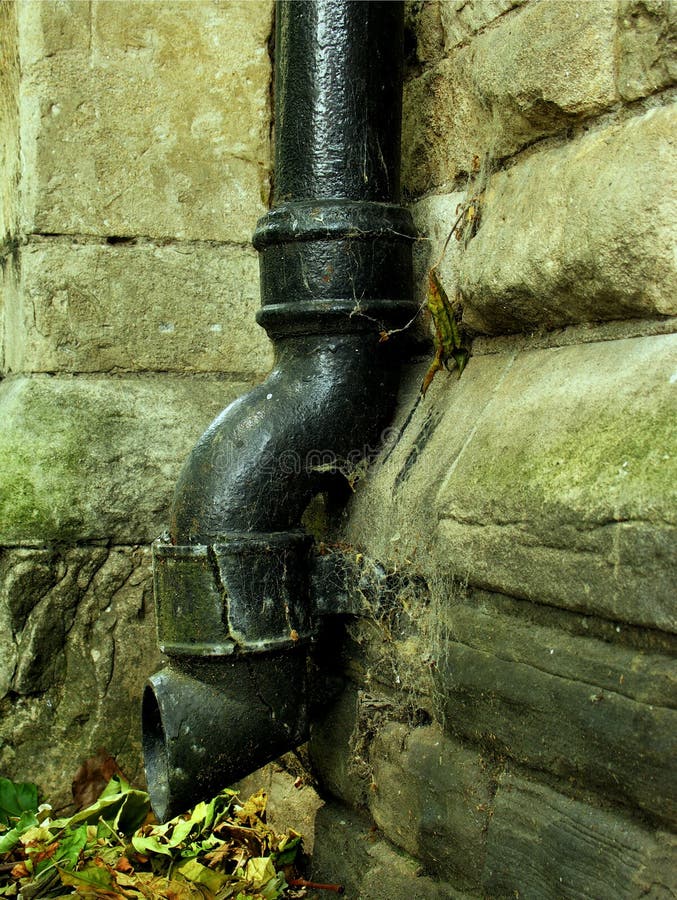 Pipe For Draining The Water From The Roof On An Old House. Rain Gutter