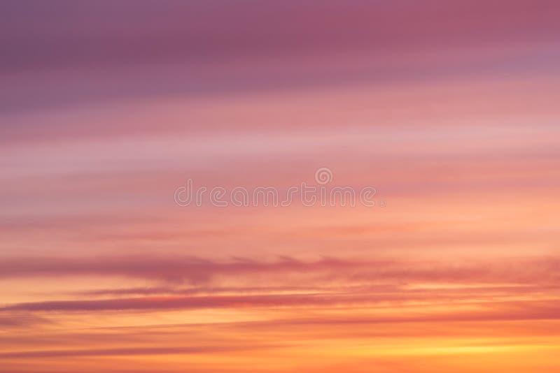 Dramatic bright soft sunrise, sunset pink orange sky with clouds background texture