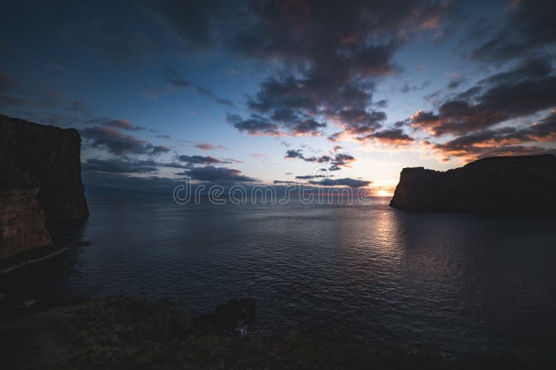 Dramatic cliffside sunset with vibrant clouds, Azores, Portugal royalty free stock images