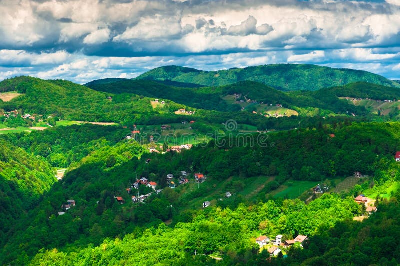 Dramatic clouds over green hills