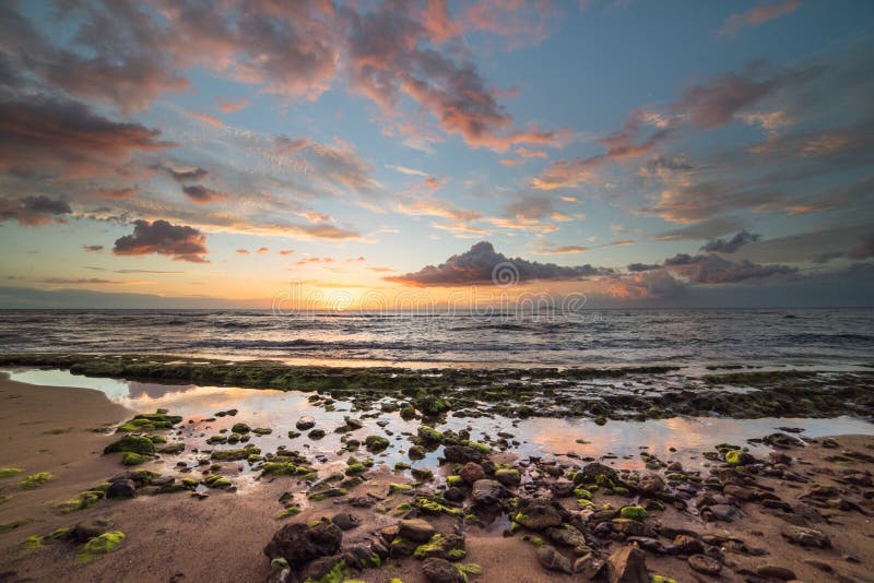 Dramatic and colorful sunset on the beach in Rincon, Puerto Rico.