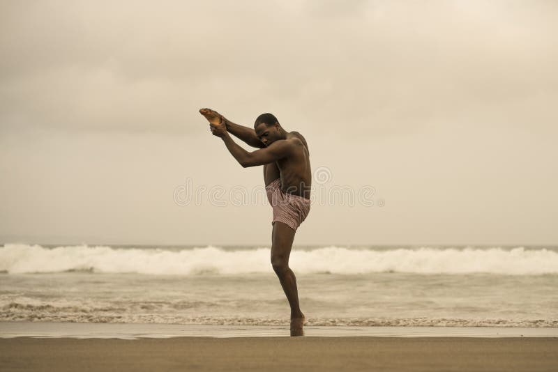 Dramatic contemporary dance choreographer doing ballet beach workout, young attractive and athletic afro black American man stock images Dramatic contemporary dance choreographer doing ballet beach workout, young attractive and athletic afro black American man stock images